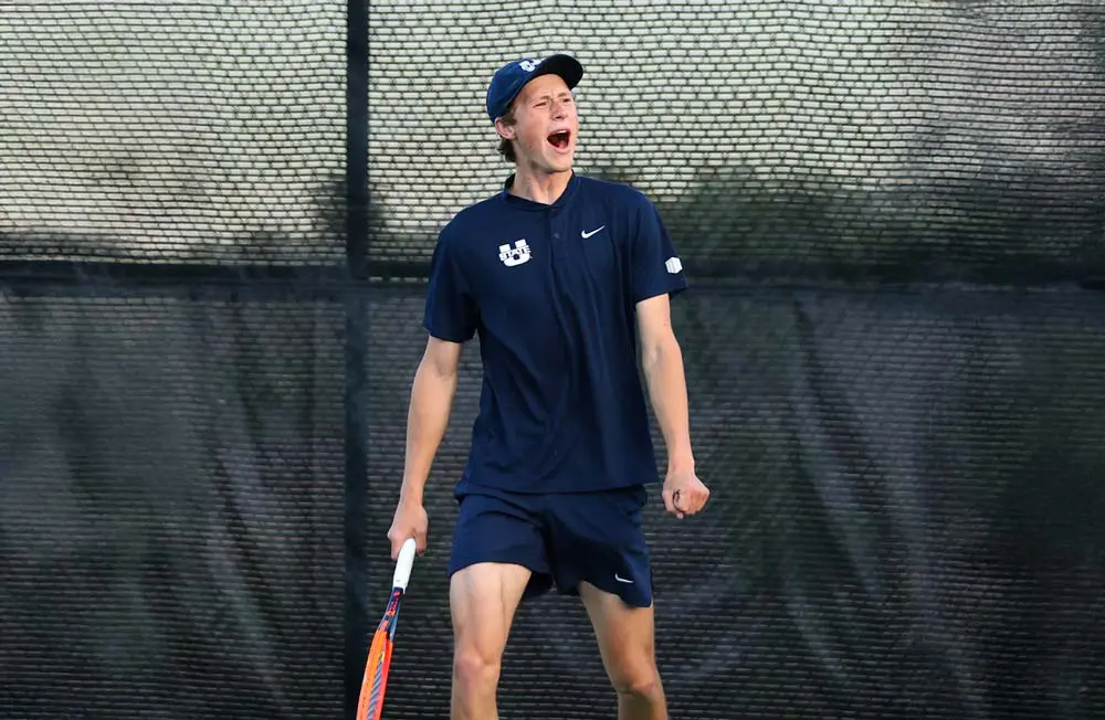 Two men's tennis players high fiving