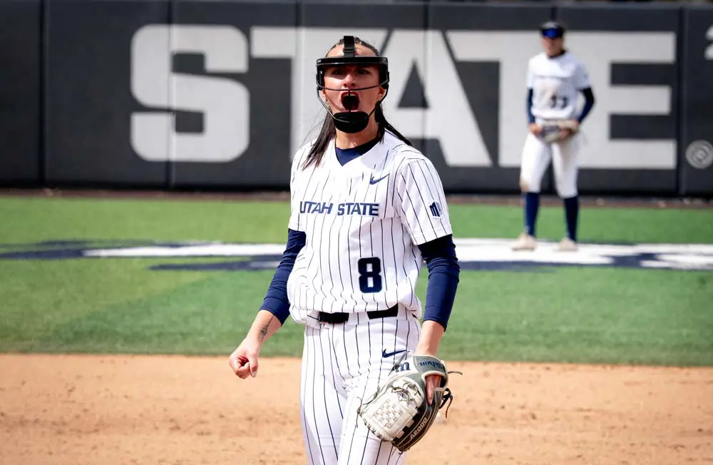 Softball player mid pitch