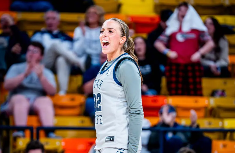 Women's basketball player dribbling down the court