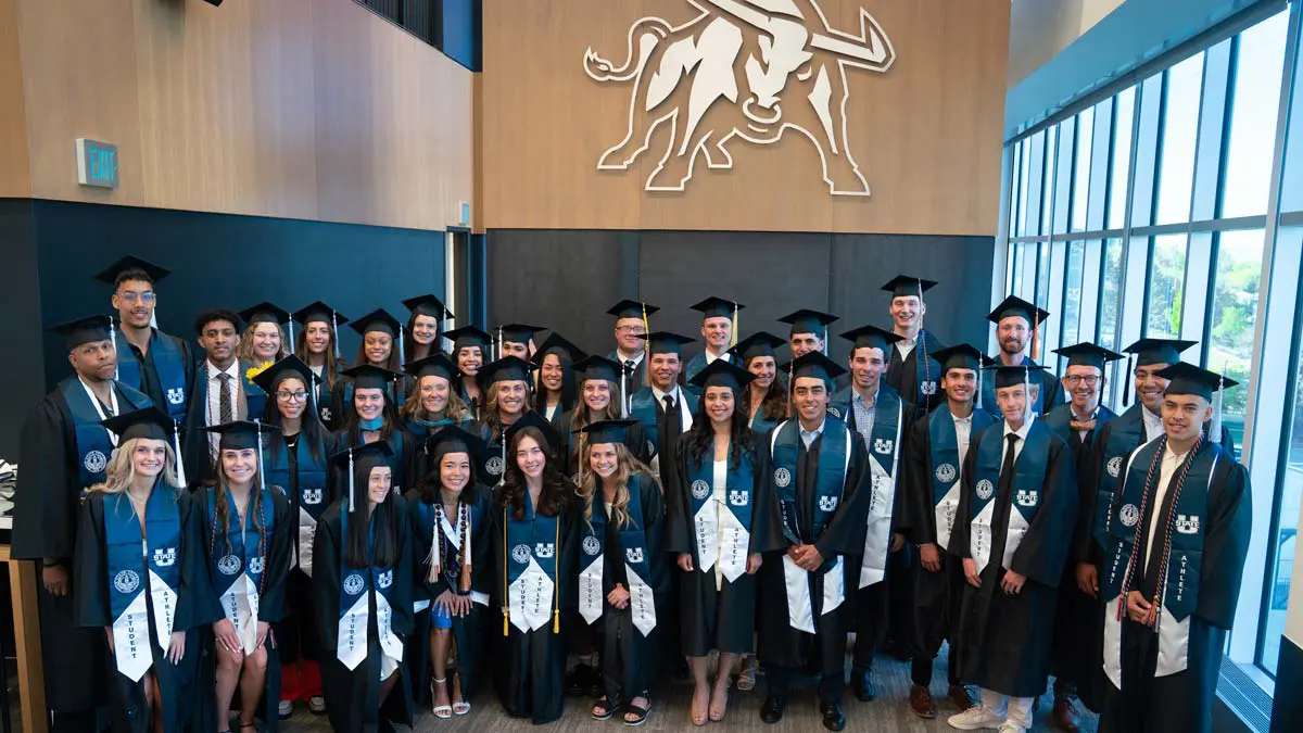 Graduates in cap and gown posing