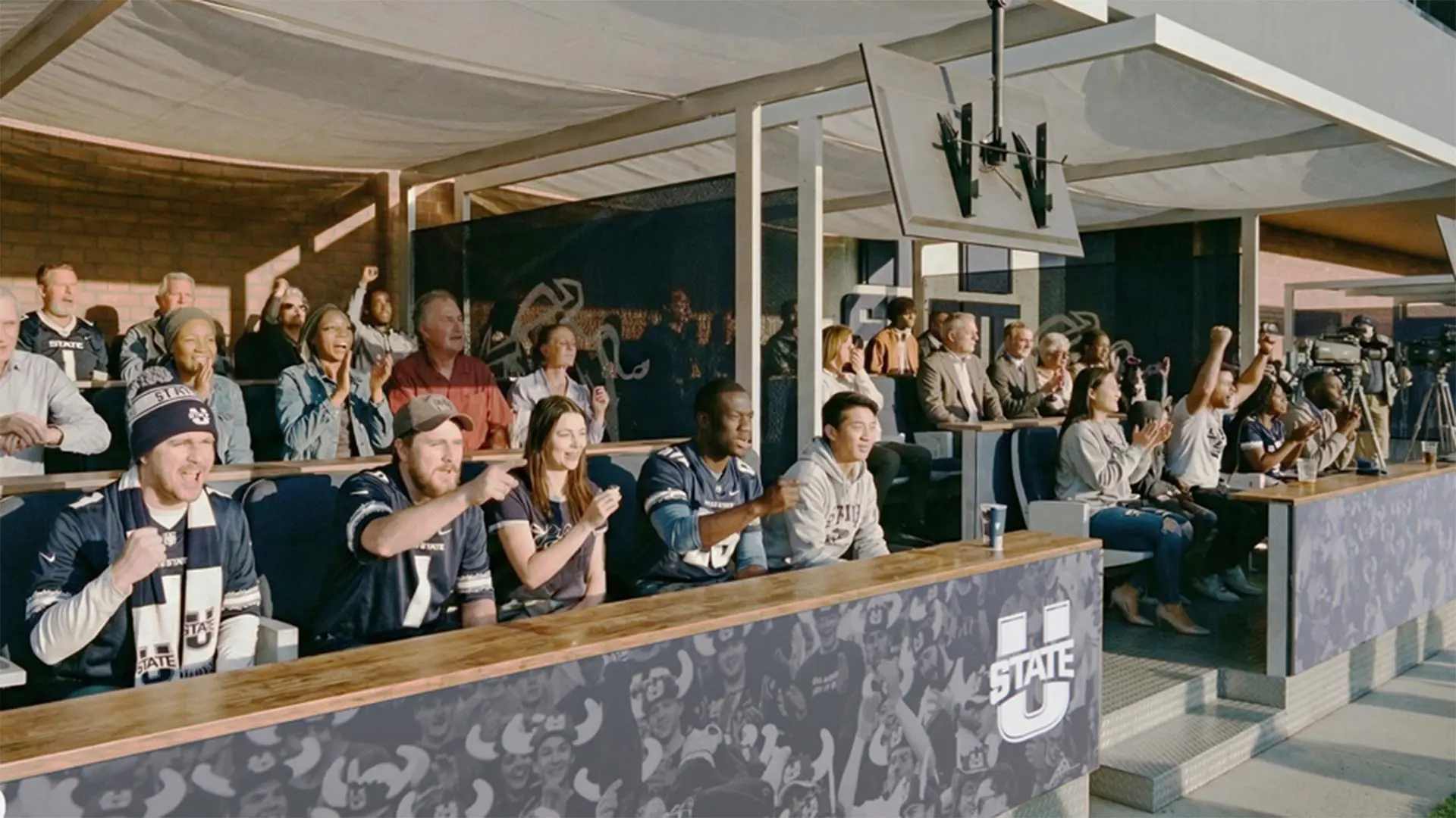 Fans enjoying a game from an indoor premium seating area